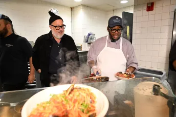Chef Zimmern watches as staff prepare Mussels Fra Diavolo