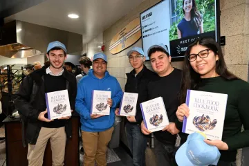 Student show off the Blue Food Cookbook