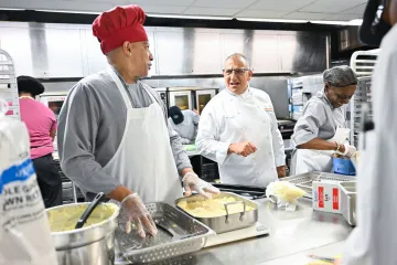 Chefs in kitchen talking