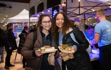 Two students smiling at the camera