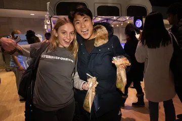 Student wearing a Ferris Forever shirt and smiling with a friend