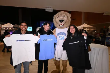 Students holding t-shirts with Roaree