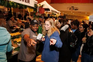 A student poses with a Ferris staff member