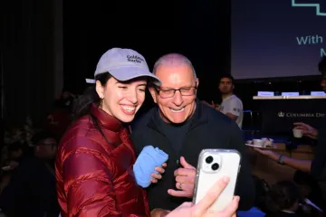 A student takes a selfie with Chef Irvine