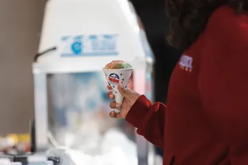 A student holding a snowcone