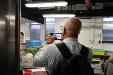 A US Army representative taking a picture of the kitchen while on the tour