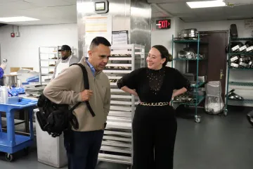 Tour attendee talking with a manager in the John Jay Dining Hall kitchen