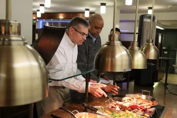 US Army representatives sampling a meal at John Jay Dining Hall