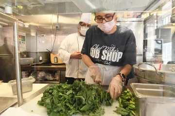 Staff member cutting fresh lettuce