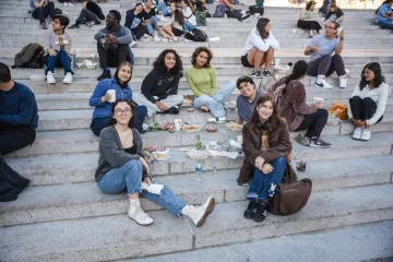 students sitting on the steps smiling