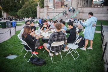 students eating together on the lawn 
