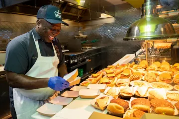 JJ's Place staff member preparing sandwiches