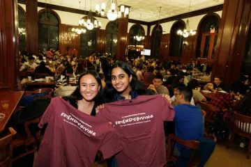 students holding up their Friendsgiving tee