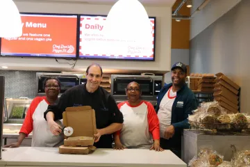 Chef Don's Pizza Pi team posing with a pizza