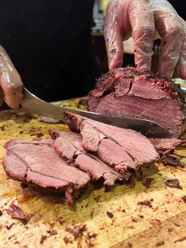 Lamb being carved on a wooden board