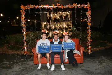 Students sitting on the couch at the photo booth