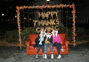 Students sitting on the couch at the photo booth