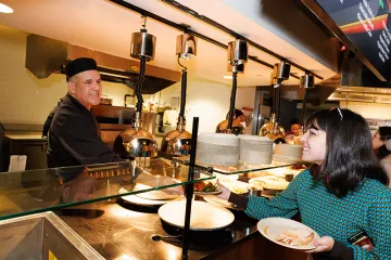 A ferris worker serves a student