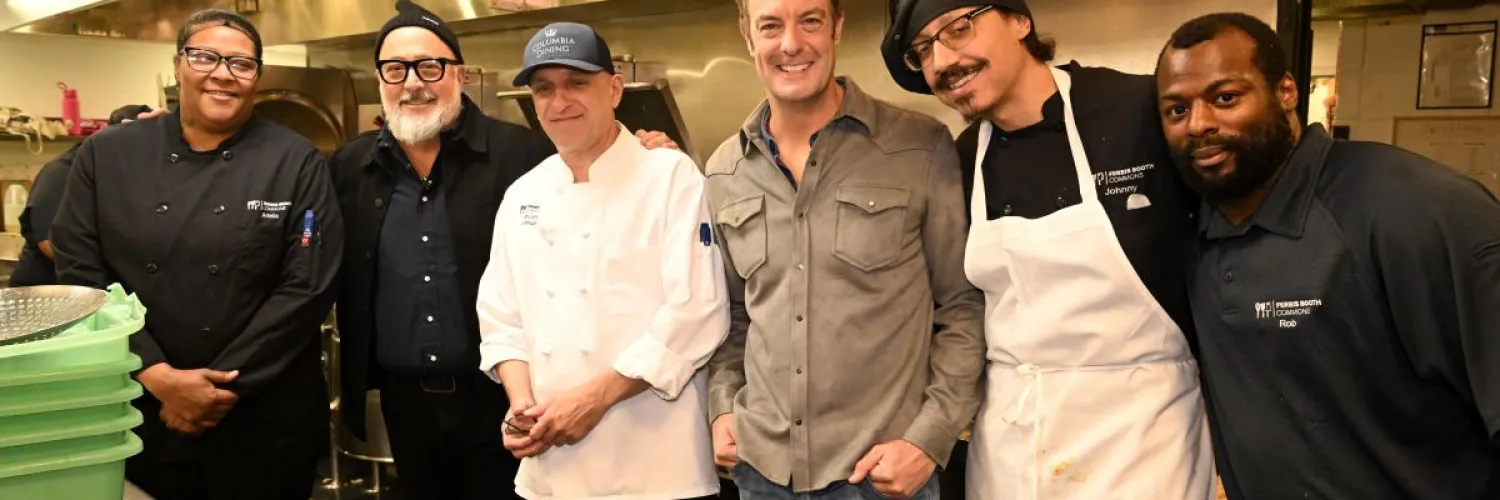 Andrew Zimmern and Barton Seaver greet members of the Columbia Dining culinary team
