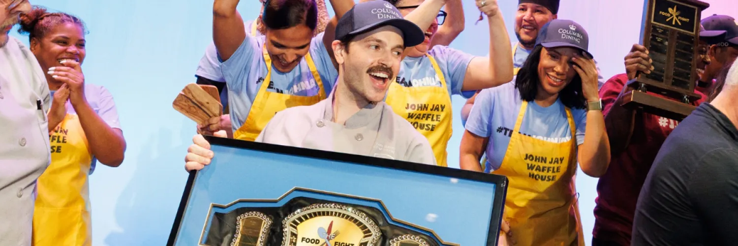 Chef Tom holding Champion Belt