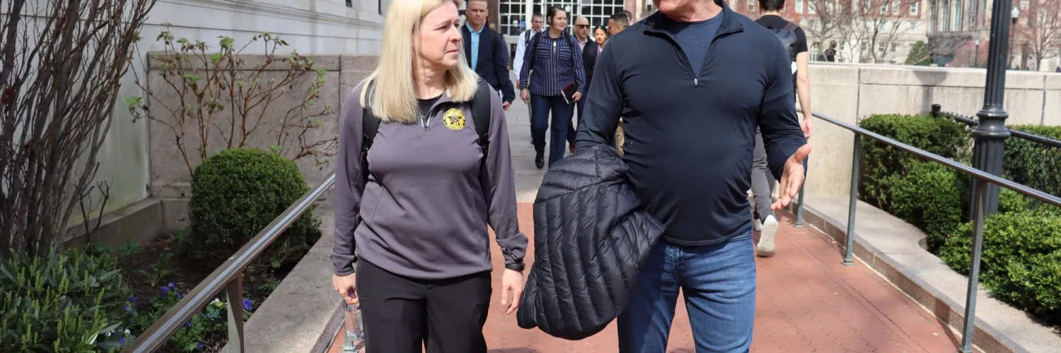 Robert Irvine walking with US Army representatives on tour