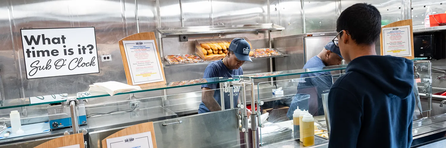a student at the Chef Mike's Sub Shop counter