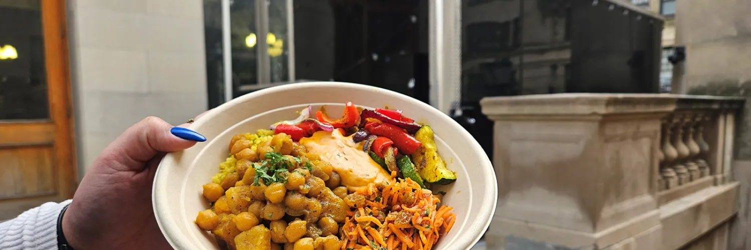 a bowl of chickpea tagine held in front of the truck